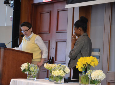 Shauna Deleon beams as Dean Sarah Neill reads the nominations other students wrote. 