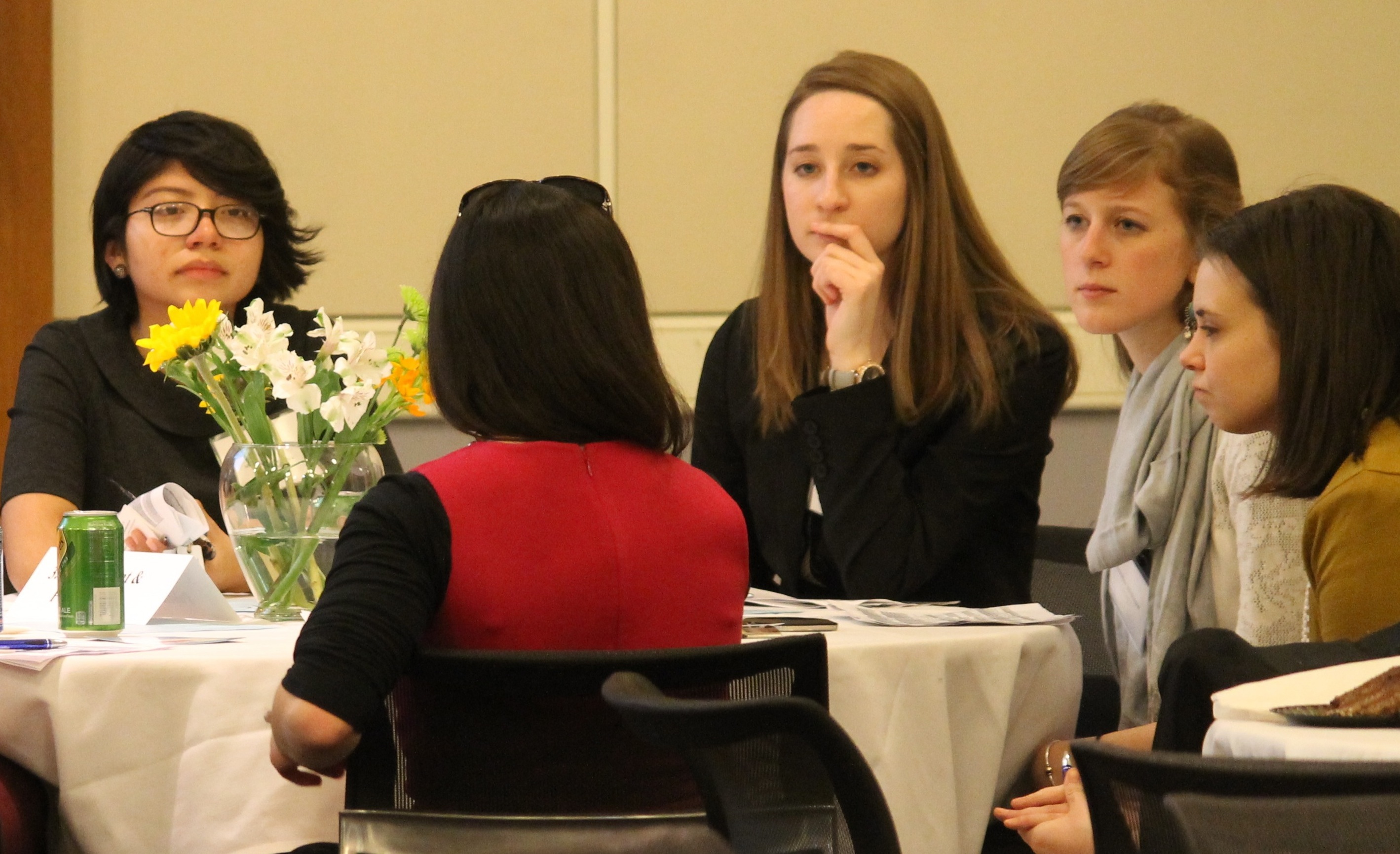 Students Marcela Jiminez, Grace Hastings, Jenny Withrow, Alison Barnett paying rapt attention to an alumna (Amelia Cordischi)
